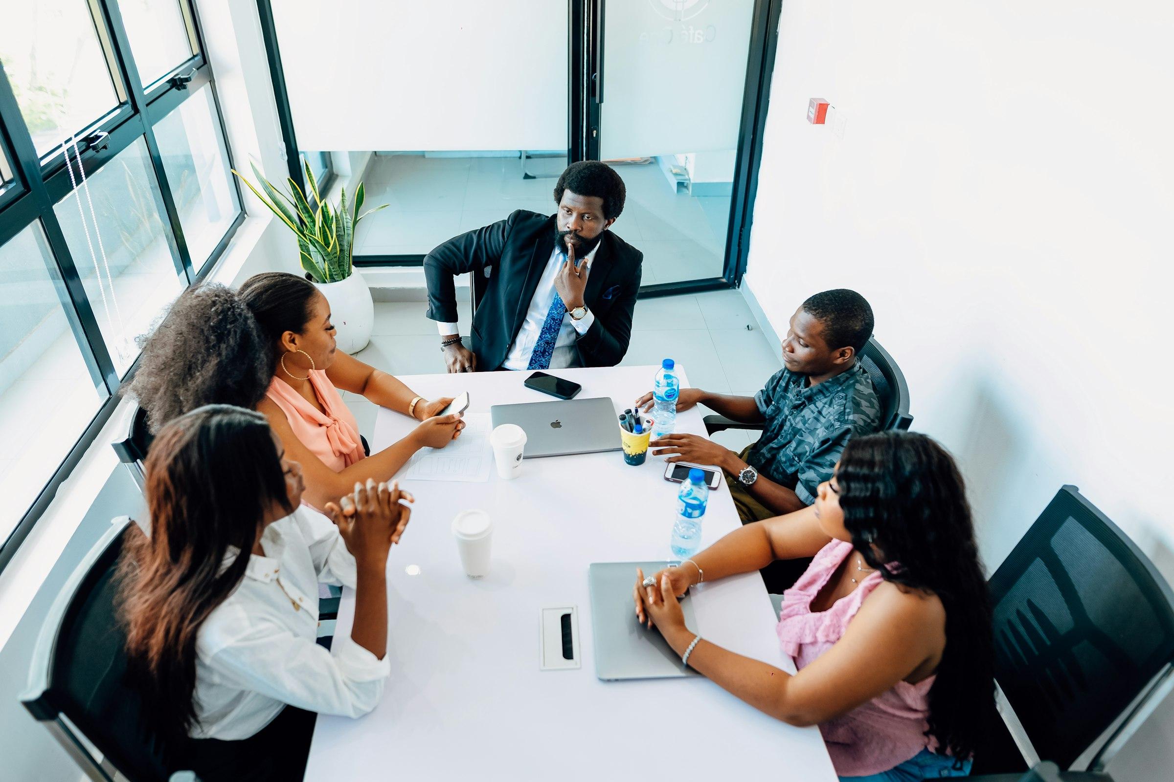 A team gathered around a table in a daylit meeting room